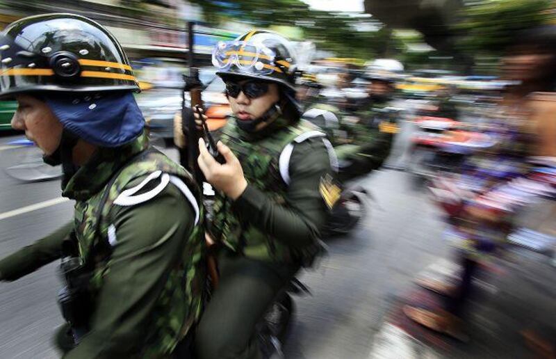 Thai soldiers ride motorcycles to a street near the residence of Thai Prime Minister Abhisit Vejjajiva when news that anti-government protesters had gathered there Sunday April 25, 2010 in Bangkok, Thailand. The embattled prime minister acknowledged he initially underestimated the protesters who have occupied central Bangkok for weeks, but he offered no initiatives Sunday to end the country's prolonged, sometimes bloody political crisis. (AP Photo/Wong Maye-E) *** Local Caption *** XWM102_Thailand_Politics.jpg