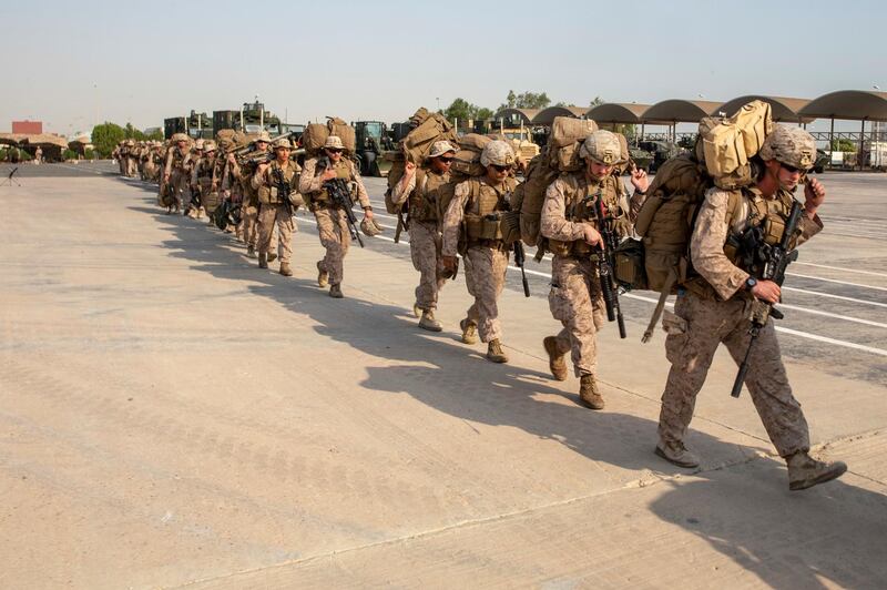 Marines with Lima Company, Battalion Landing Team 3/5, 11th Marine Expeditionary Unit prepare to load gear onto a landing craft, air cushion at Kuwait Naval Base, Kuwait City. Reuters