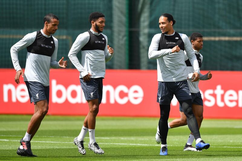 Liverpool's German-born Cameroonian defender Joel Matip (left) and Liverpool's Dutch defender Virgil van Dijk take part in training. AFP