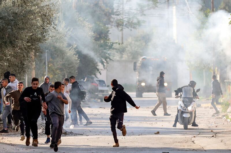 Palestinians run for cover. AFP