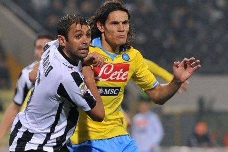 Udinese's Danilo Larangeira, left, fights for the ball with Napoli's Edinson Cavani. AFP