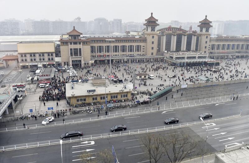 A motorcade, foreground, arrives at Beijing Railway Station in Beijing on Tuesday, March 27, 2018 amid speculation about a visit to Beijing by North Korean leader Kim Jong Un. Kyodo News via AP