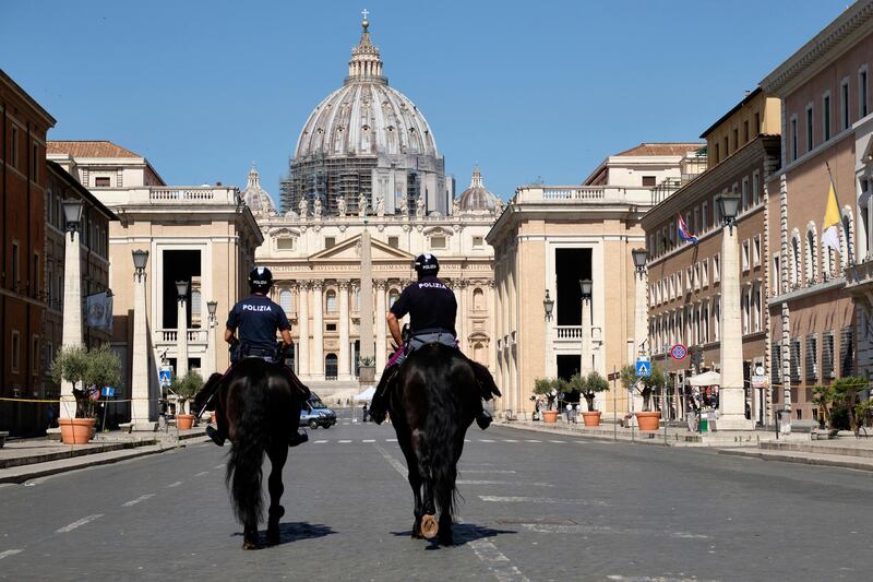 Horse mounted police officers patrol Via della Conciliazione, the street leading to St. Peter's Basilica at the Vatican, on the occasion of the Feast of Rome's Patrons Saints Peter and Paul, in Rome Monday, June 29, 2020. (Mauro Scrobogna/LaPresse via AP)