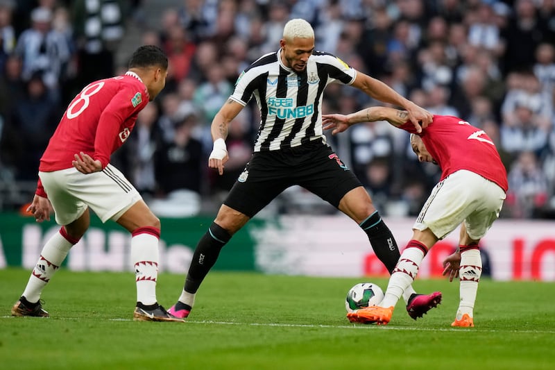 Newcastle's Joelinton challenges for the ball with Manchester United's Casemiro, left, and Antony. AP 