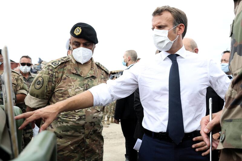 French President Emmanuel Macron meets members of the military mobilised for the reconstruction of the port of Beirut, in Beirut, Lebanon. Reuters
