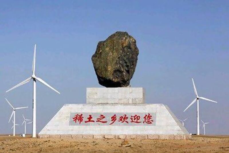 A monument, which reads: "Home of rare earths welcomes you", stands in a field of wind turbines near the town of Damao in China's Inner Mongolia Autonomous Region. Reuters