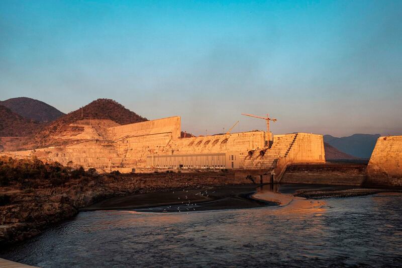 A general view of the the Grand Ethiopian Renaissance Dam (GERD), near Guba in Ethiopia, on December 26, 2019. The Grand Ethiopian Renaissance Dam, a 145-metre-high, 1.8-kilometre-long concrete colossus is set to become the largest hydropower plant in Africa.
Across Ethiopia, poor farmers and rich businessmen alike eagerly await the more than 6,000 megawatts of electricity officials say it will ultimately provide. 
Yet as thousands of workers toil day and night to finish the project, Ethiopian negotiators remain locked in talks over how the dam will affect downstream neighbours, principally Egypt. / AFP / EDUARDO SOTERAS
