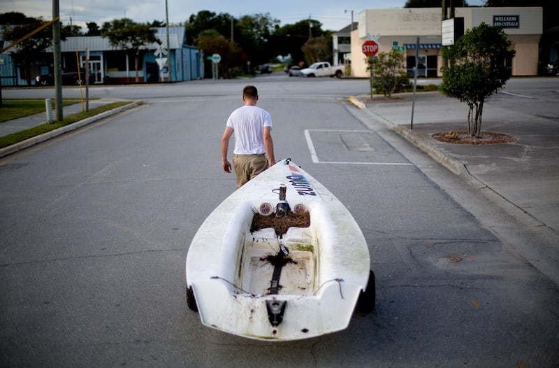 Emmett West pulls his boat from a nearby marina to secure it at his home in Morehead City, North Carolina. AP