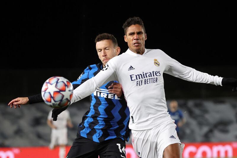 Real Madrid defender Raphael Varane vies for the ball against Internazionale's Ivan Perisic. EPA