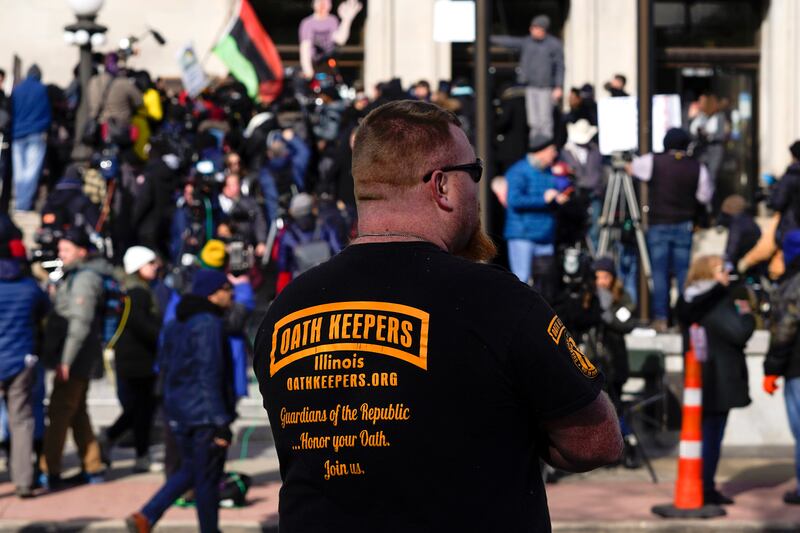 A man wearing an Oath Keepers shirt stands outside the Kenosha County Courthouse in Kenosha, Wisconsin. AP