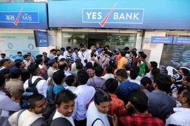 Indian depositors crowd for withdrawals outside a Yes Bank branch in Ahmedabad, India on Friday. India's finance minister assured panicky depositors that their money is safe as the central bank seized control of the private lender. Photo: AP