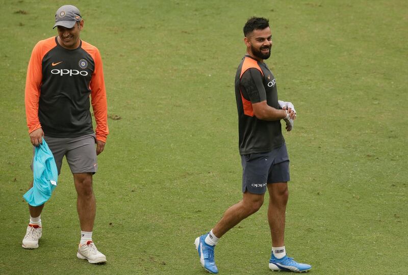 Indian cricket players Mahendra Singh Dhoni, left and Virat Kohli attend a practice session before the first one-day international cricket match against West Indies in Gauhati, India, Friday, Oct. 19, 2018. (AP Photo/Anupam Nath)