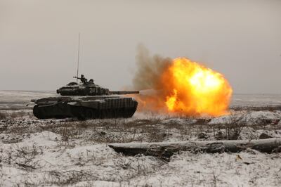 A Russian tank fires as troops take part in drills at the Kadamovskiy firing range in the Rostov region in southern Russia. AP