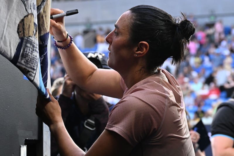 Ons Jabeur signs autographs inside Margaret Court Arena. AFP