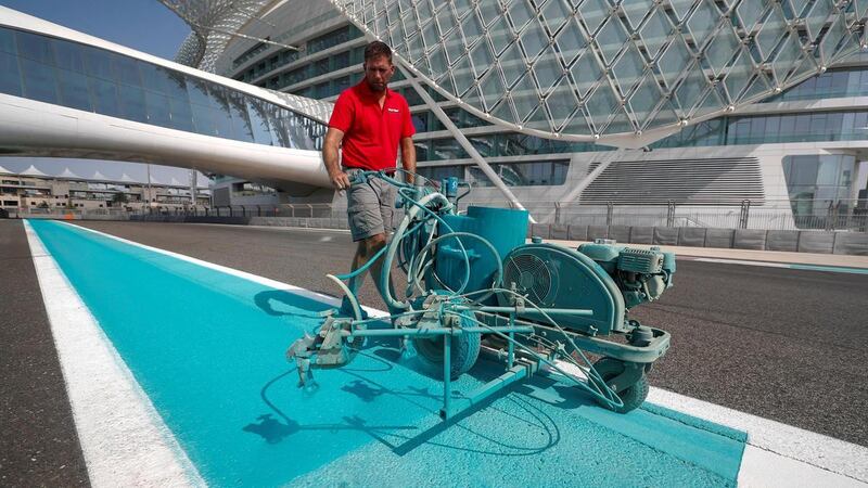 A worker applying paint to Yas Marina Circuit. Courtesy Seven Media