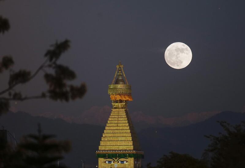 The moon rises over an upper portion of the Boudha stupa in Kathmandu, Nepal. Narendra Shrestha / EPA