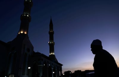 A Muslim leaves to perform maghrib prayer after breaking his fast during Ramadan, outside Al Farooq Mosque in Dubai. EPA 