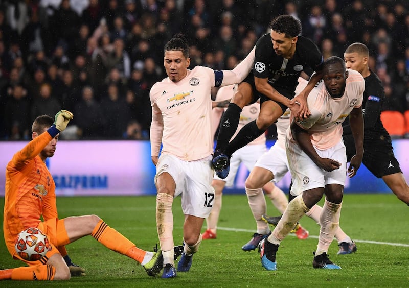 Manchester United goalkeeper David de Gea saves from PSG defender Marquinhos. AFP