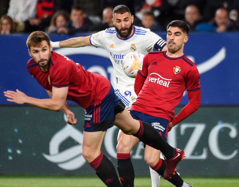 Karim Benzema is crowded out by Osasuna midfielder Jon Moncayola and defender Nacho Vidal. AFP