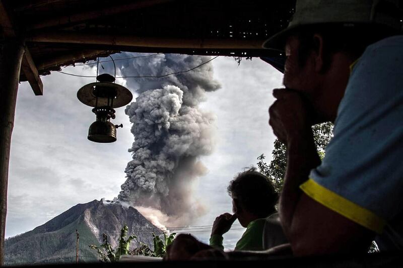 Villagers in Beganding village in Karo, North Sumatra province look on as Mount Sinabung spews volcanic ash. The volcano roared back to life in 2010 for the first time in 400 years. After another period of inactivity, it erupted once more in 2013 and has remained highly active since. Ivan Damanik / AFP / May 19, 2017