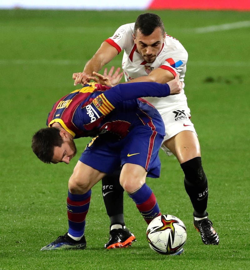 Sevilla's Joan Jordan (R) in action against Lionel Messi. EPA