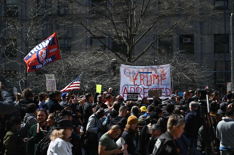 Opponents of Mr Trump protest outside the Manhattan District Attorney's office. AFP