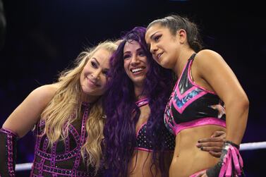 Sasha Banks, centre, and Bayley, right, pictured with Natalya, will walk out of Elimination Chamber as the WWE's first women's tag champions. Image courtesy of WWE