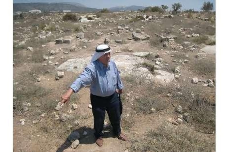 Abdul Rahman Kayyal, who lost his home during an Israeli incursion, stands at the cemetery in al Birwa.