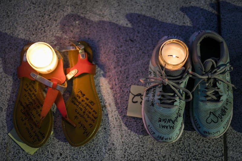 Candles sit inside pairs of shoes displayed outside the Capitol building during a protest against the government's reporting of the death toll from Hurricane Maria in San Juan, Puerto Rico. Xavier Garcia / Bloomberg