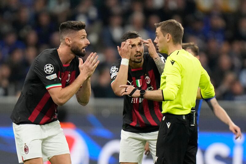 AC Milan's Olivier Giroud, left, pleads with referee Clement Turpin. AP 