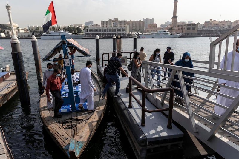 DUBAI, UNITED ARAB EMIRATES. 25 FEBRUARY 2021. COVID - 19 Standalone. Deira souk during the time of Covid. Commuters wearing face mask disembark an abra. (Photo: Antonie Robertson/The National) Journalist: Nick Webster. Section: National.