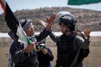 A protesters faces off with an Israeli soldiers during a demonstration against settlements in the occupied West Bank village of Qaryout. AP