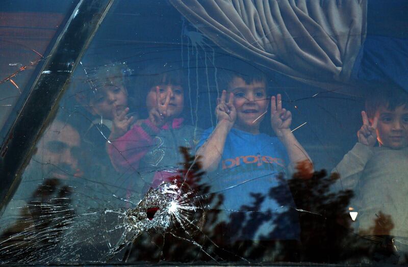 TOPSHOT - Children look out of the window of a bus upon their arrival at the Abu al-Zindeen checkpoint near the northern Syrian town of al-Bab after Jaish al-Islam fighters and their families from the former rebel bastion's main town of Douma were evacuated from the last rebel-held pocket in Eastern Ghouta on April 3, 2018.
Russia-backed regime forces have retaken control of 95 percent of Eastern Ghouta since February 18 through a combination of a deadly air and ground assault and evacuation deals. / AFP PHOTO / Nazeer al-Khatib