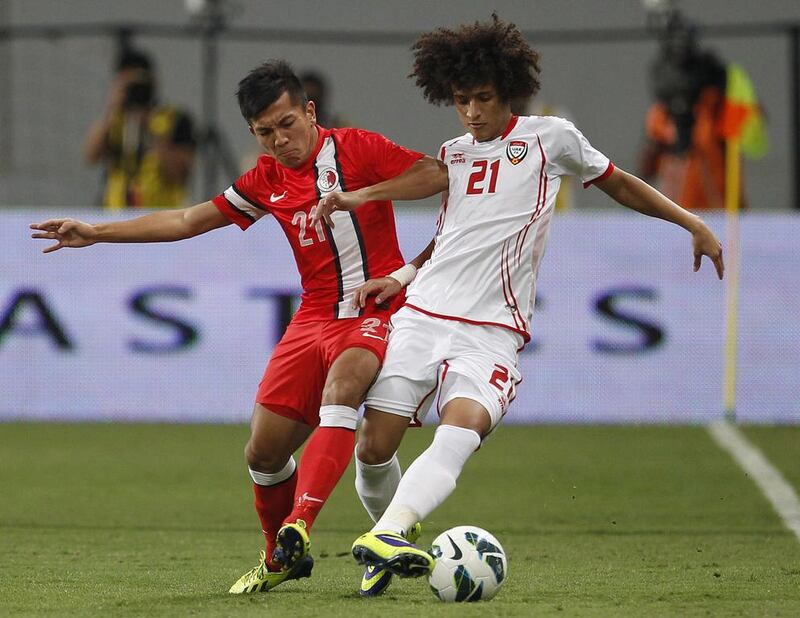 Hong Kong’s Kwok Kin Pong, left, fights for the ball on Friday night with UAE’s Omar Abdulrahman, who later scored the third goal for his team. AFP

