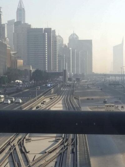 The car is seen in the distance stopped just before the tram station at Dubai Marina Mall.