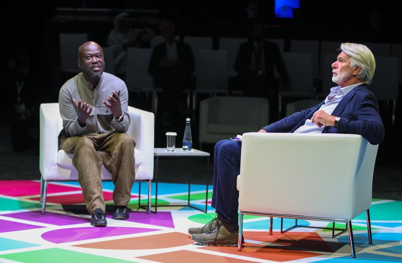 Sir David Adjaye, left, discusses his design for the Abrahamic Family House with Chris Dercon at the Culture Summit Abu Dhabi. Victor Besa / The National