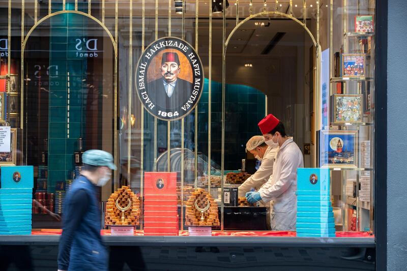 A Turkish delight sellers wearing face masks work in their store, in Istanbul, Turkey.  EPA