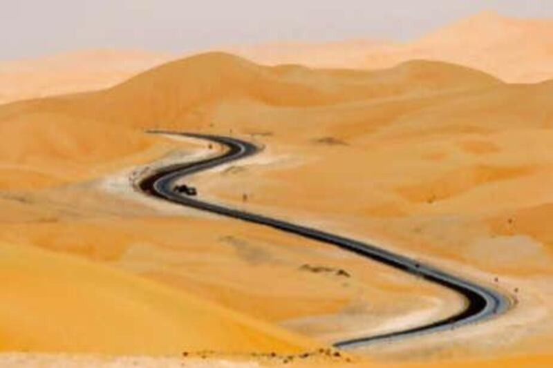 Empty promise: a road snakes through the - less and less - Empty Quarter, which is gradually being transformed from desert to destination.