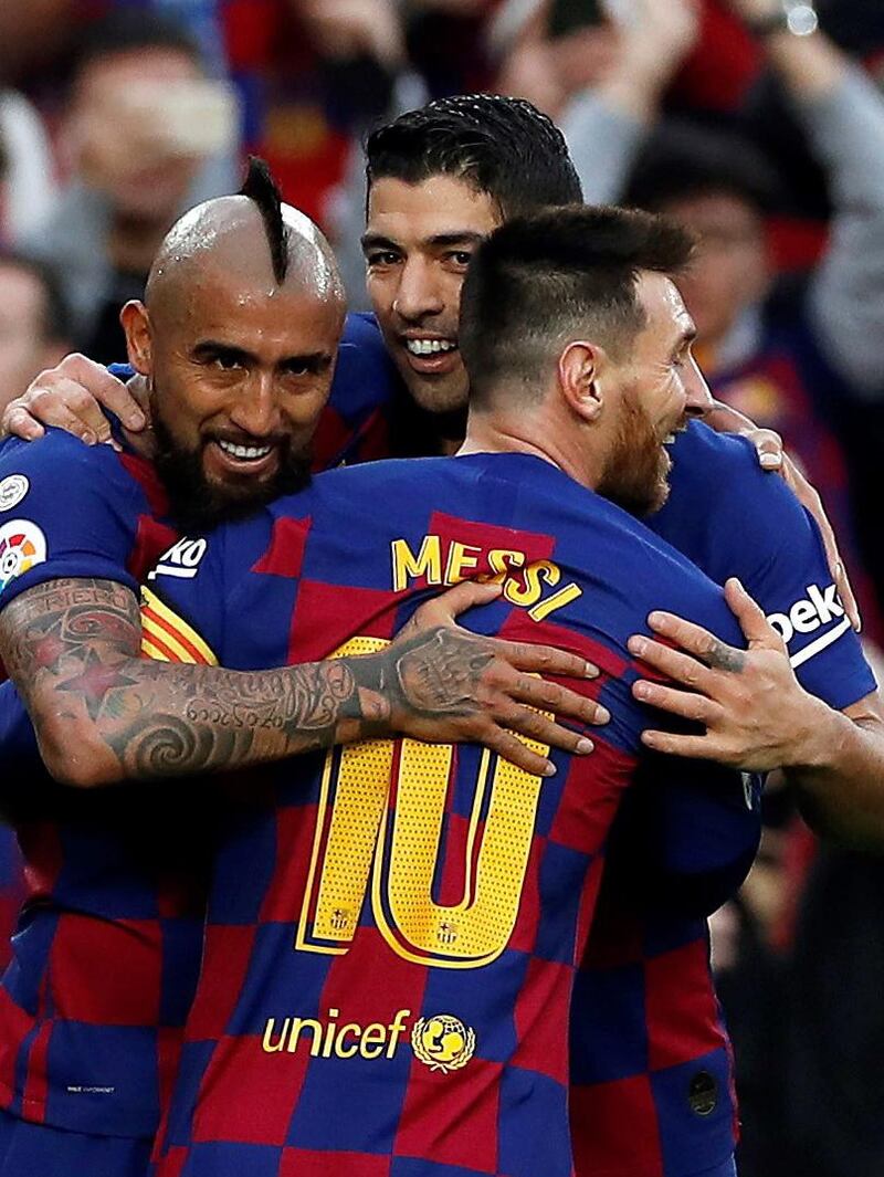 Vidal celebrates with teammates Luis Suarez and Lionel Messi. EPA