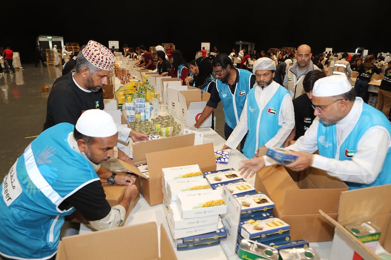 Volunteers preparing UAE Aid boxes for Gaza Aid Campaign at the Festival City Arena in Dubai