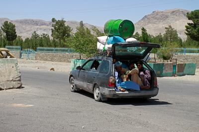 Afghans flee fighting between the Taliban and security forces on the outskirts of Herat, west of Kabul. AP