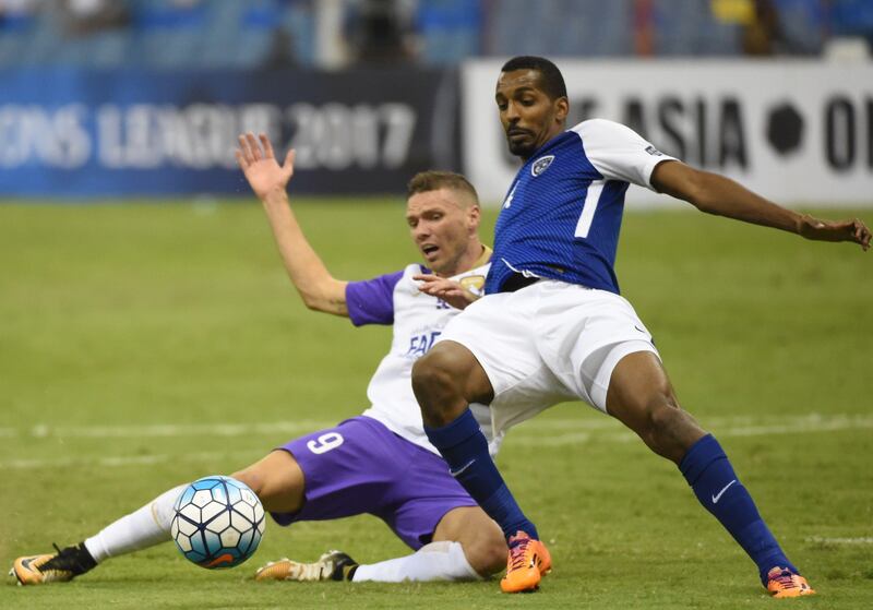 Al-Hilal's defender Abdullah Zori (R) vies for the ball with Al-Ain's player Marcus Berg during their AFC Asian Champions League quarter final second leg football match at the King Fahad Stadium in Riyadh on September 11, 2017. / AFP PHOTO / FAYEZ NURELDINE