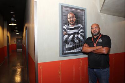 Ayman Abdelrhman, managing partner of Prison Island adventure destination with his photo at the Prison Island at Abu Dhabi Mall. Pawan Singh / The National