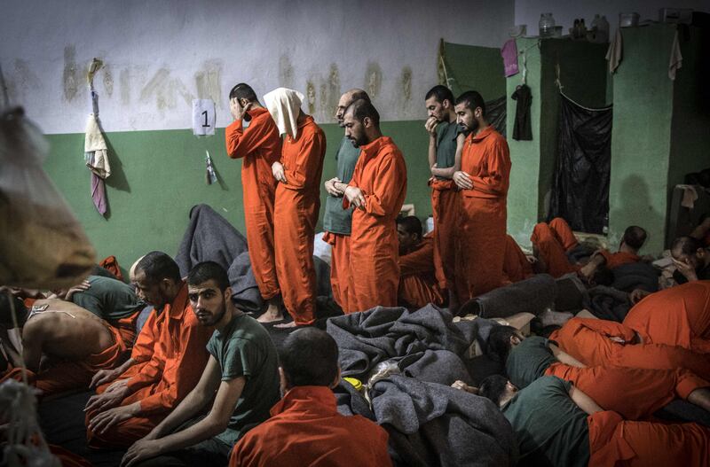 Men suspected of being affiliated with ISIS pray in a cell of Sinaa prison in the Syrian city of Hassakeh. AFP