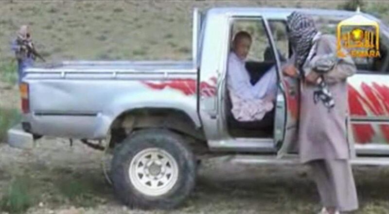 Screen grab from video obtained from Voice Of Jihad Website, of US soldier Sgt Bowe Bergdahl sitting in a vehicle guarded by the Taliban in eastern Afghanistan, awaiting the arrival of US forces who were going to take him home. (AP Photo/Voice Of Jihad Website via AP video