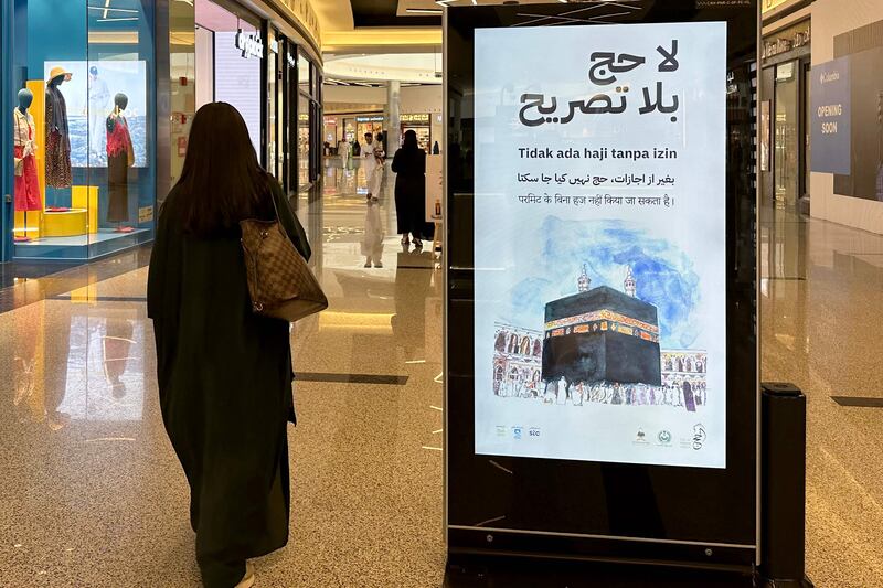 Hajj season at a shopping mall in Riyadh and a billboard reminds passers-by they need a permit to perform a pilgrimage. AFP