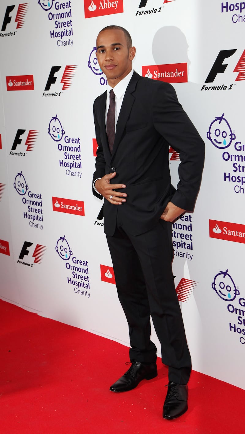 Lewis Hamilton, in a black suit with a burgundy tie, attends the F1 Charity Party in aid of Great Ormond Street Hospital at the Victoria and Albert Museum on June 17, 2009. Getty Images