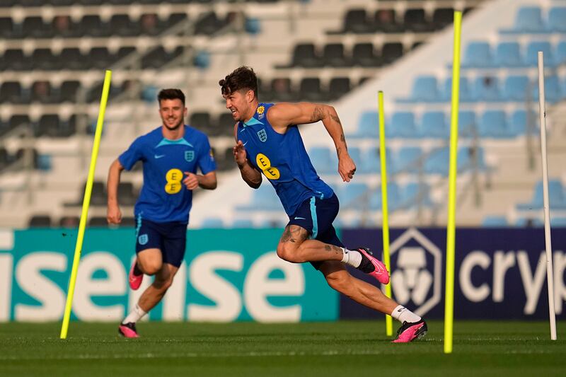 England's John Stones, right, takes part in drills during training. AP