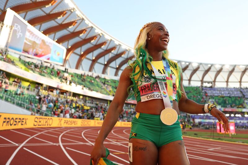 Shelly-Ann Fraser-Pryce celebrates after winning gold in the women's 100m. AFP
