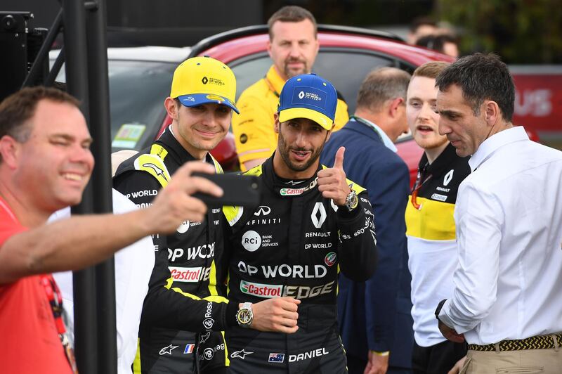 Renault's Australian driver Daniel Ricciardo (centre R) and Renault's French driver Esteban Ocon (centre L) pose for a photo as they attend the unveiling of their team's new car at the Albert Park circuit ahead of the Formula One Australian Grand Prix in Melbourne.  AFP